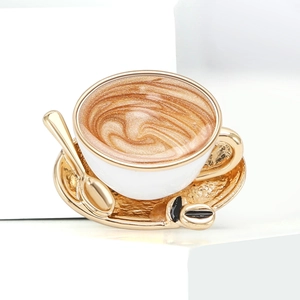 Detailed macro view of a coffee cup enamel brooch with gold trim and glitter art