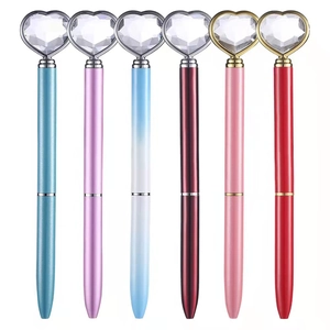 Set of 6 metal ballpoint pens featuring large heart-shaped crystal diamonds on top