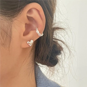 Minimalist 925 sterling silver heart stud and braided ear cuff worn by a model