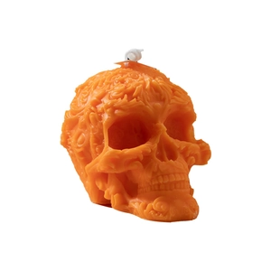 Orange skull candle with intricate relief carving for Halloween home decor and gifts