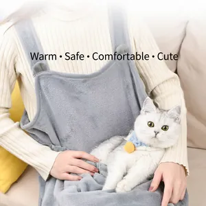Grey plush cat carrier apron with kangaroo pouch for holding pets while sitting on a sofa