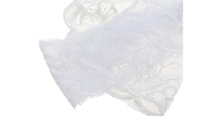 Detailed macro view of white floral lace headband with delicate scalloped edges for babies