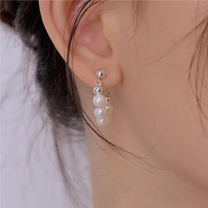 Elegant 925 sterling silver pearl hoop earrings worn on ear for a minimalist jewelry look