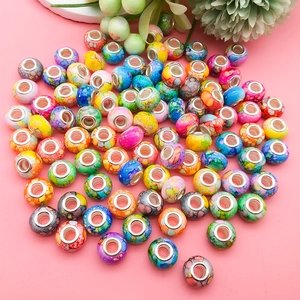 Macro view of assorted colorful marble ink texture large hole beads with metal inner cores