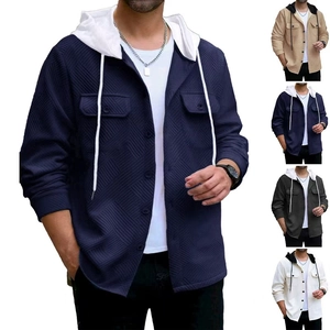 Detail of waffle knit fabric texture and buttons on a men's hooded patchwork jacket