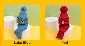 Detailed view of knitted hats and scarves in red and lake blue with bear embroidery