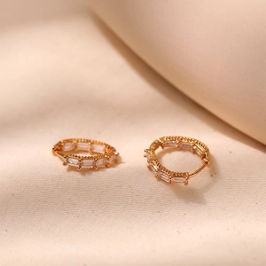 Macro shot of 18K gold plated hoop earrings featuring rectangle cubic zirconia stones