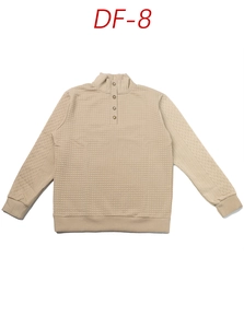 Detail of beige waffle knit texture with quarter-button stand collar on a long-sleeve top