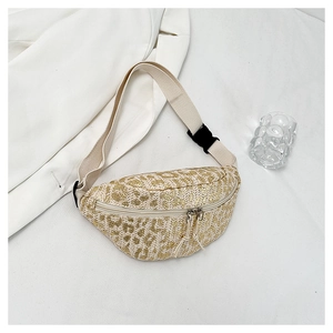 Detail of golden leopard straw fanny pack texture with beige adjustable strap and buckle
