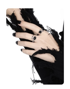 Close-up of S925 silver irregular crisscross rings with black onyx stones on finger
