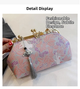 Detail of silk brocade handbag with butterfly clasp and elegant long silk tassel pendant