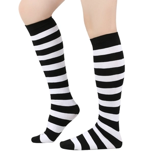 Detail of black and white striped knee-high socks showing knit texture and elastic fit