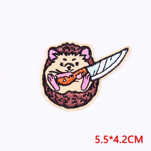 Detail of cartoon hedgehog embroidery patch with dagger showing fine needlework texture