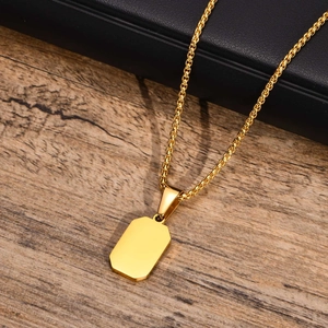 Close-up of polished gold rectangular pendant with high-quality box chain on wood background