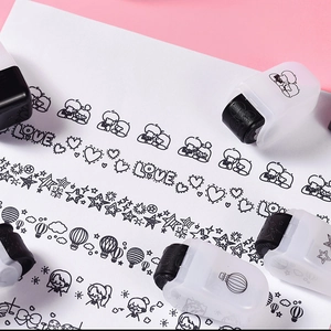 Close-up of cute cartoon roller stamps creating heart and star patterns on paper