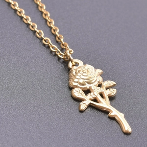 Macro shot of 18k gold plated stainless steel rose pendant with fine petal detailing