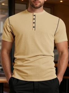 Detail of waffle textured fabric and four-button placket on khaki Henley shirt for men