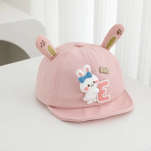 Detail of pink baby baseball cap featuring 3D rabbit ears and a cute cartoon bunny doll