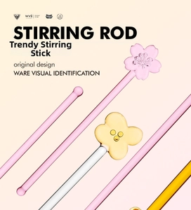 Macro shot of heat-resistant glass stir sticks featuring pink sakura and yellow petals