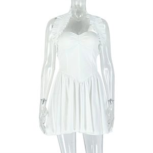 Macro detail of white halter neck dress featuring pleated texture and tailored backless cut
