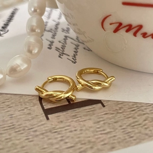925 silver gold-plated twisted knot hoop earrings shown with pearls on a card