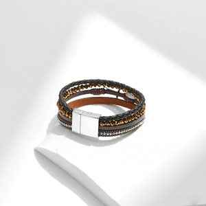 Detailed macro of a multilayer bohemian bracelet with magnetic clasp on a white stand