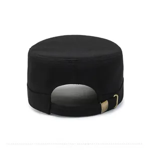Detail view of the adjustable bronze metal back buckle on a black canvas army cadet cap