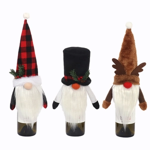 Three Nordic Christmas gnome wine bottle covers with red plaid and reindeer antler hats