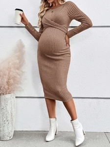 Detail of ribbed knit texture and stylish front twist knot on brown maternity dress