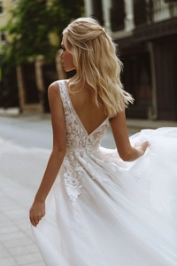 Exquisite back view of French bridal gown with floral lace embroidery and sheer mesh train