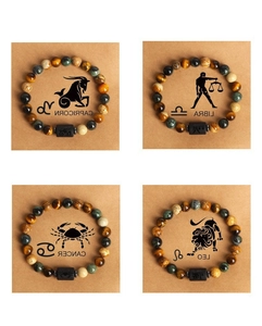 Detail of natural stone bracelets with zodiac signs on tiger eye and marble stones