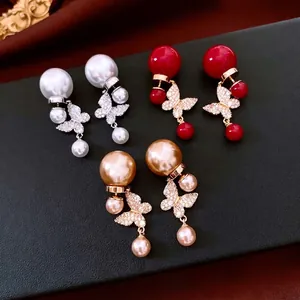 Boucles d'oreilles papillon en perles plaquées or 18 carats en blanc, rouge et or