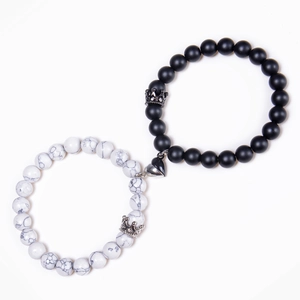 Detail of magnetic heart clasp connecting white turquoise and matte black beaded bracelets