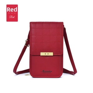 Close-up of red leather crossbody bag featuring quilted texture and gold metal buckle