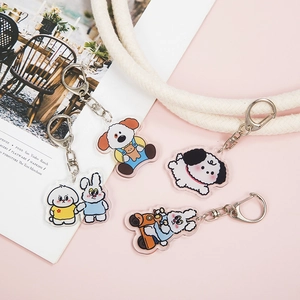 Cute acrylic animal keychains with rabbit and puppy designs on a pink background
