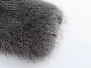 Macro view of luxurious dark grey faux fur texture on short jacket collar detail