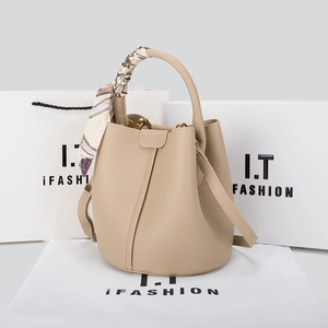 Detail of apricot leather bucket bag with litchi grain and floral silk scarf handle
