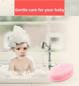 Detailed close-up of soft pink silicone baby bath brush with dense massage bristles