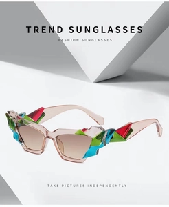 Detail of colorful geometric crystal accents on translucent pink cat-eye sunglasses