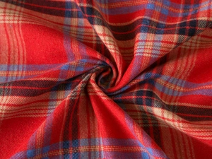 Macro shot of red plaid sofa throw fabric showing soft texture and woven twill patterns