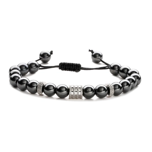 Close-up of stainless steel beads and engraved metal spacers on adjustable bracelet