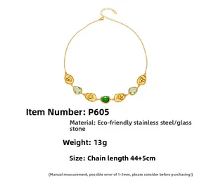 Detailed view of gold stainless steel necklace with green glass stones and lava texture