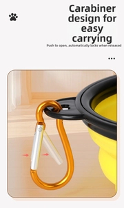 Detail of yellow collapsible pet bowl showing the secure carabiner clip mechanism