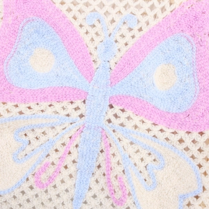 Crocheted crop top featuring a blue and pink butterfly pattern on off-white knit