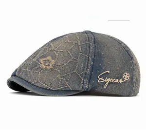 Close-up of nostalgic blue denim newsboy cap with embroidery and geometric texture