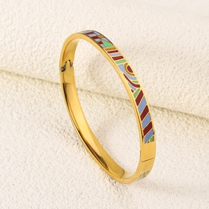 Macro view of golden 18K plated stainless steel bracelet with colorful enamel geometry