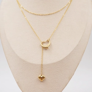 Double-layered gold hollow heart pendant necklace with elegant Y-shape design on mannequin