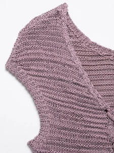 Detailed close-up of purple knit vest showing intricate hollow-out texture and stitching