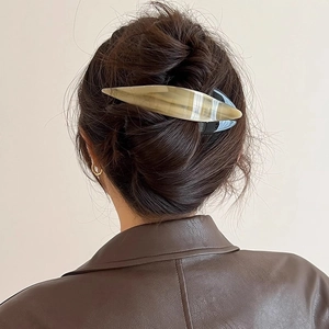 Minimalist beige acetate hair claw clip for women shown on a model's hair from behind