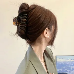 Amber tortoiseshell pumpkin shark clip for thick hair shown on model's head